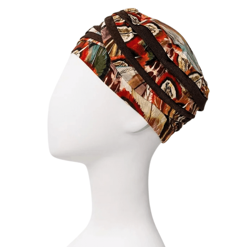 Shanti turban i Tribal Feathers mønster på mannequin, set fra højre side. Mørkebrune bånd og fjerdetaljer