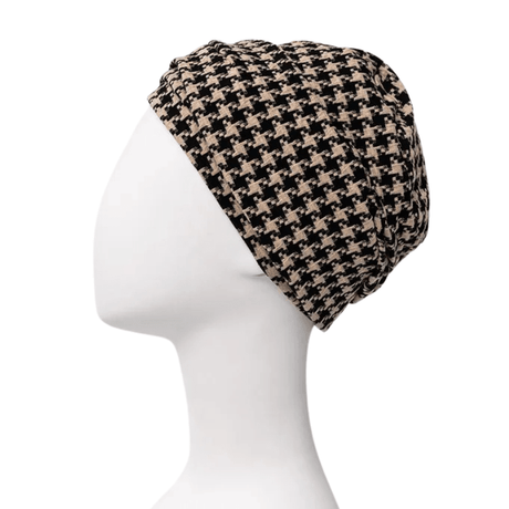 Lea turban i sort og beige houndstooth-mønster set fra siden på en hvid mannequin